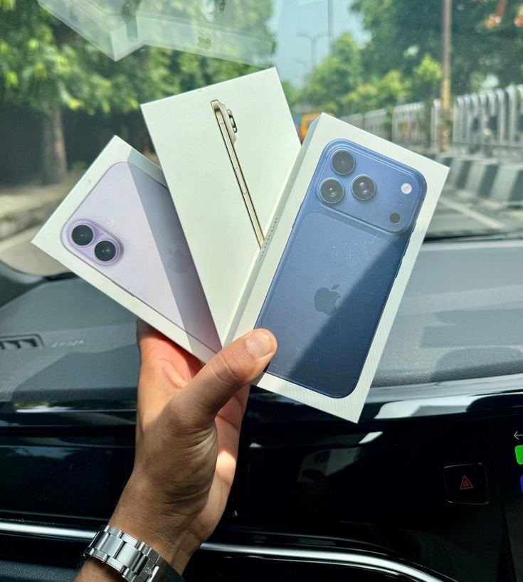 Três caixas de iPhone seguradas em leque sobre o painel de um carro